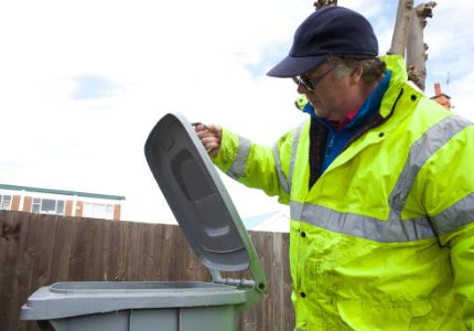 Man looking in bin