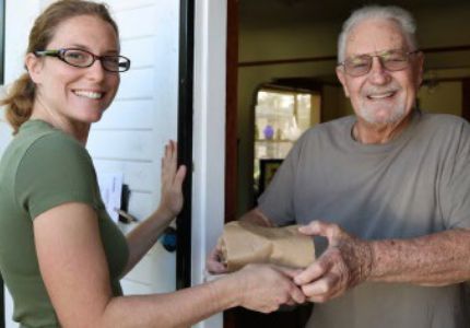 Food bank volunteer carries produce to distribute to Californians in need