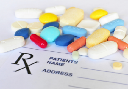 Various medicine pills on top of prescription form