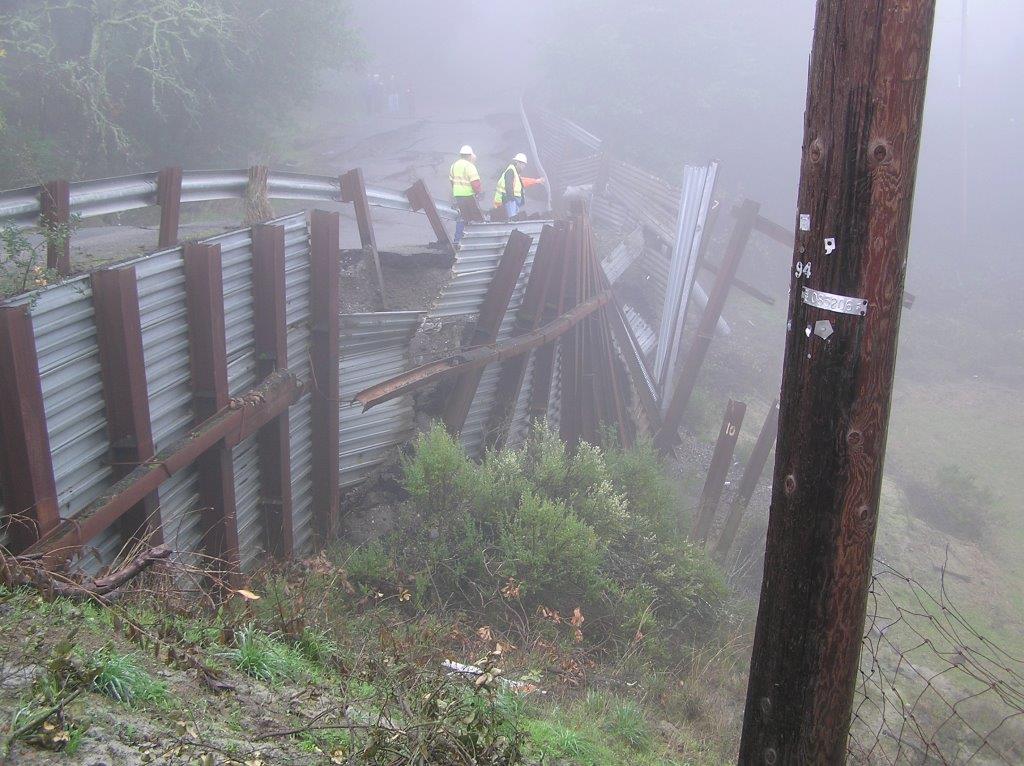 Sonoma Mountain road failure with crumpled metal railing