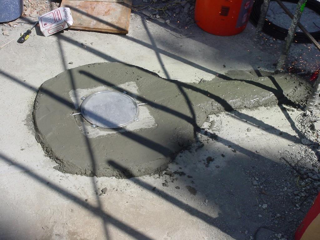 Pressure cell placed in wet concrete of a wall foundation.