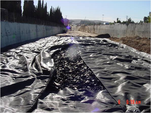 TDA backfill wrapped in geotextile fabric on construction site.