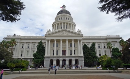 People walking in front of the California State Capitol building