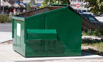 Big green empty dumpster bin