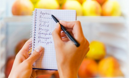 Person writing a grocery list