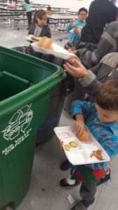child recycling food waste