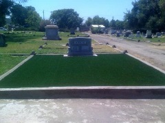 Synthetic turf made from crumb rubber used on a gravesite with headstone