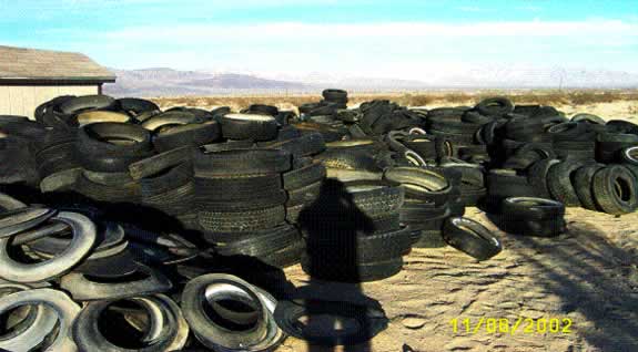 Tires piled up and scattered, including treads and sidewalls