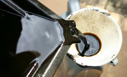 Used motor oil being poured into a funnel