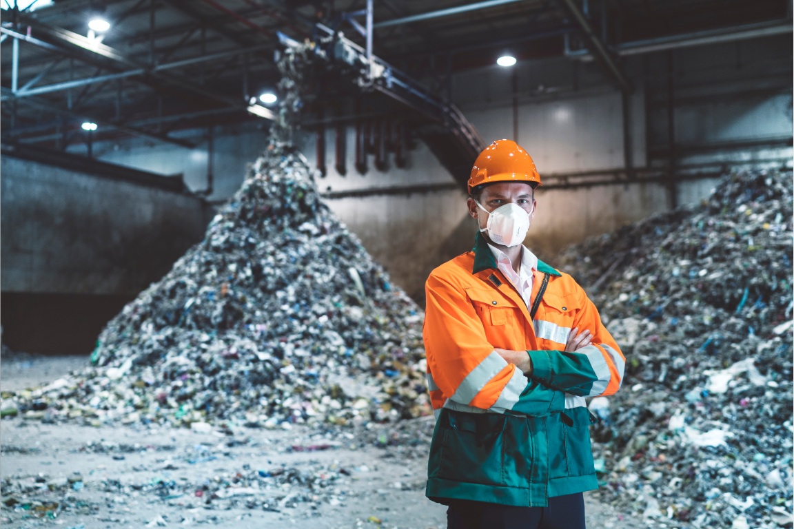 Person wearing safety gear in a recycling facility