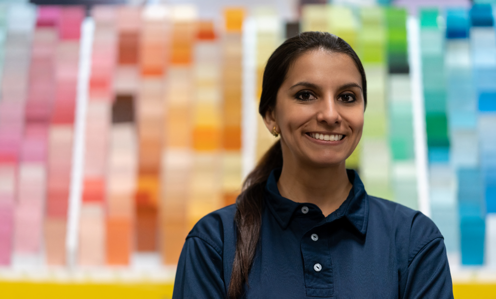 person in front of paint samples