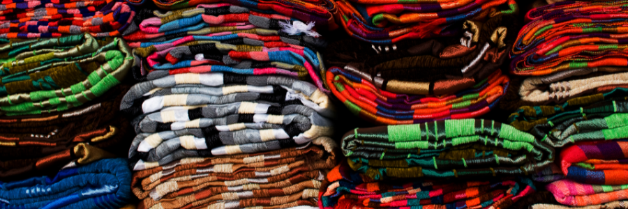image of multicolor folded textiles (fabrics)