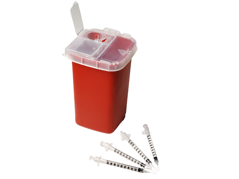 The image depicts a red sharps disposal container with its lid open, surrounded by several used syringes on a white background.